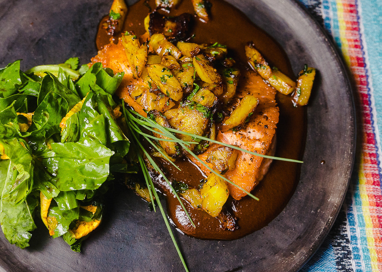 GRILLED SALMON WITH MOLE ROJO, PINEAPPLE, PLANTAINS AND MIXED GREENS