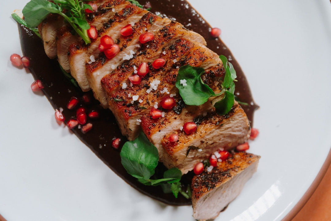 Seared Pork Loin with Mole Negro, Winter Greens & Pomegranate
