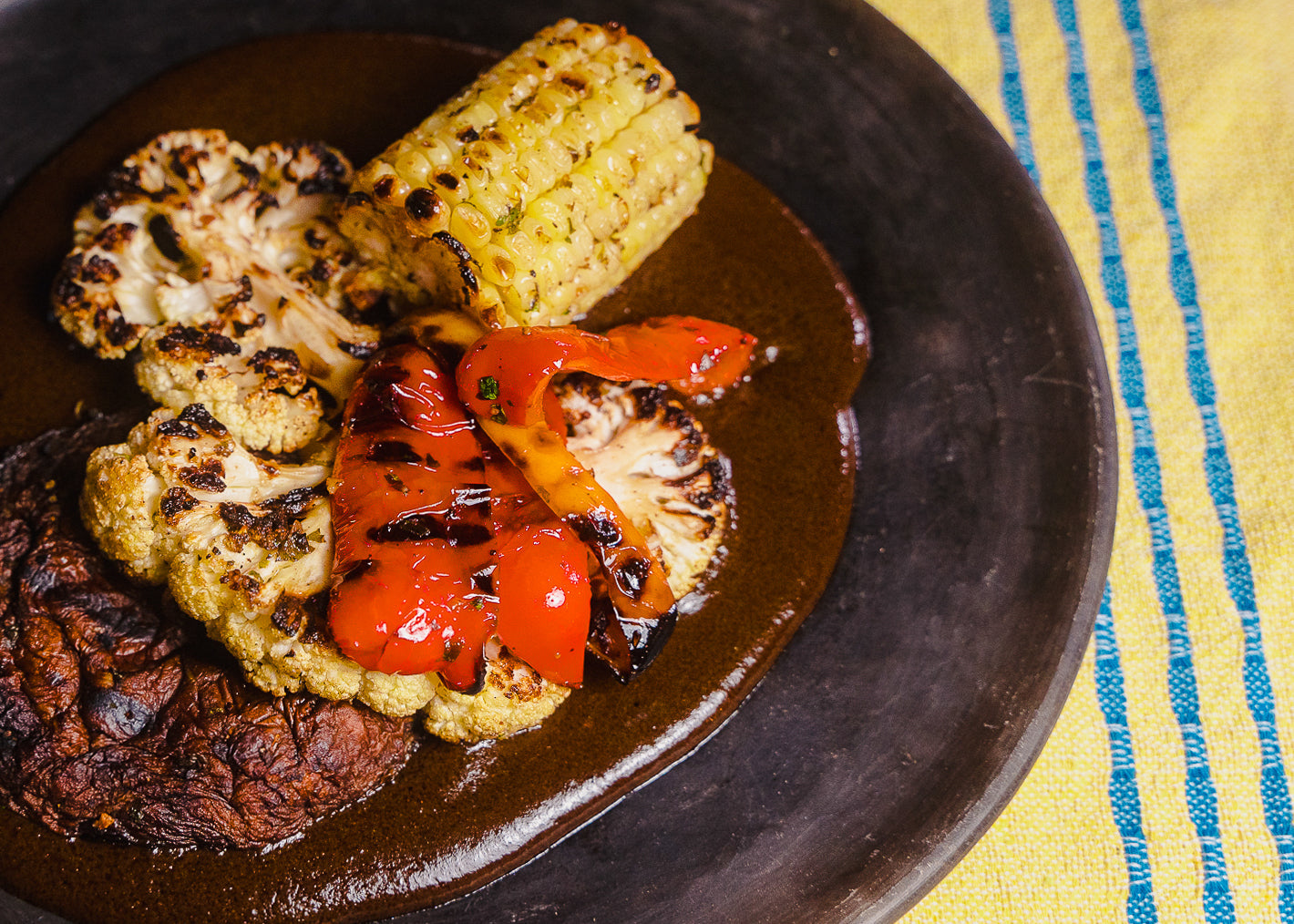 GRILLED PORTOBELLO MUSHROOMS AND CAULIFLOWER STEAKS WITH MOLE NEGRO SAUCE