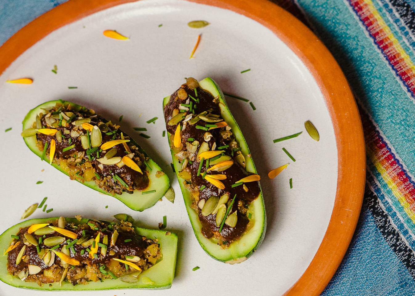 STUFFED GARDEN SQUASH WITH MOLE ROJO, QUINOA AND VEGETABLES